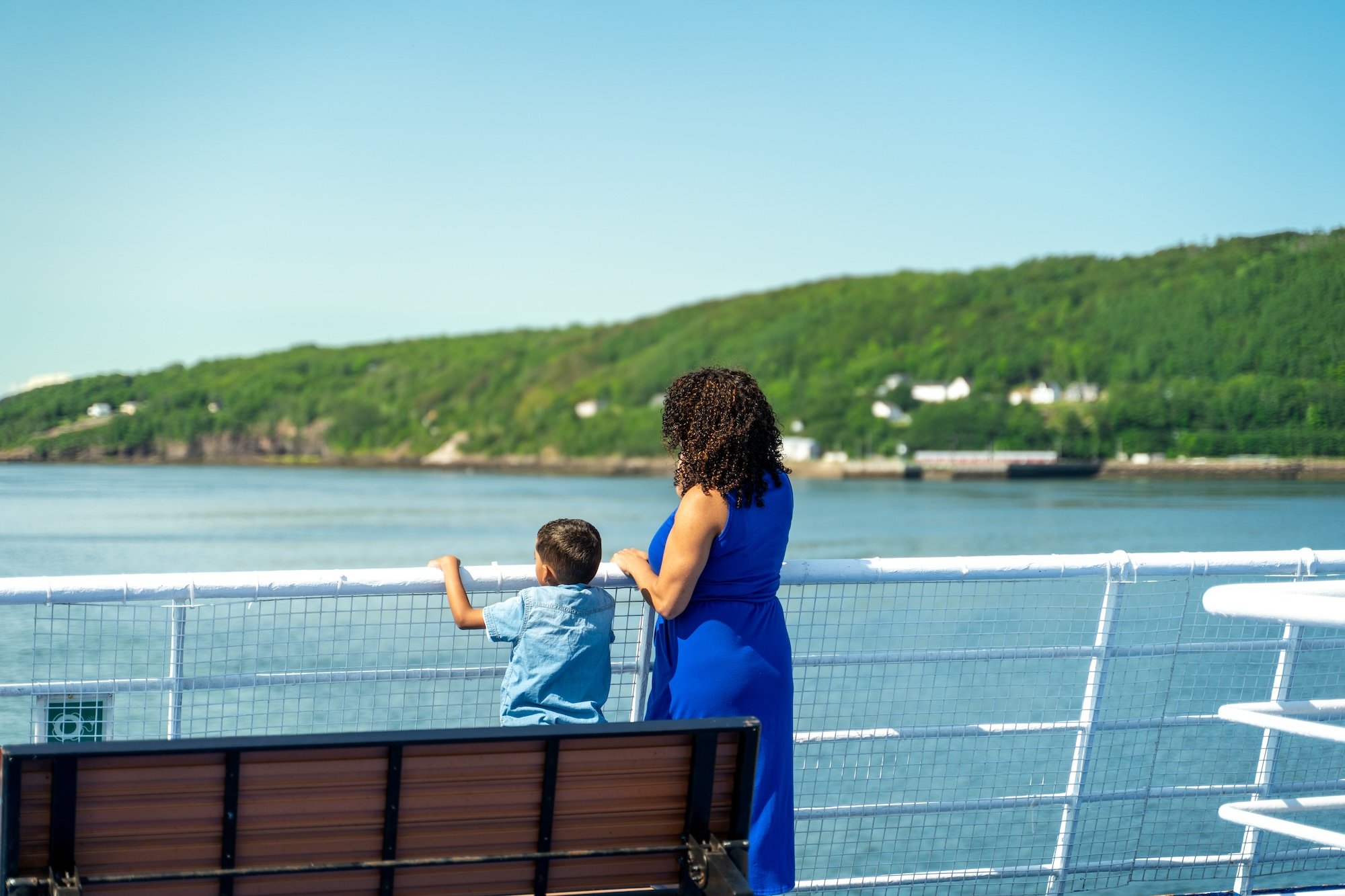 A mother and son look out over the railing on the MV Fundy Rose