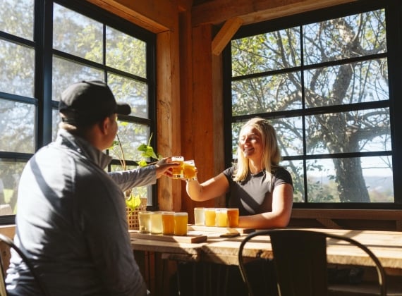 A couple enjoying some drinks at a rustic bar