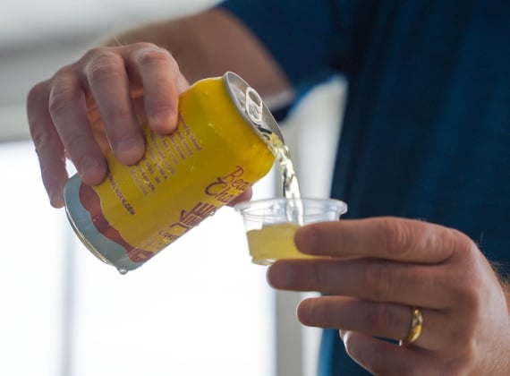 Male pouring a beer sample