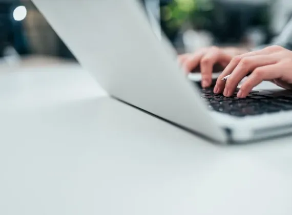 Female typing on her laptop