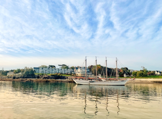 A tall ship docked on a calm harbour.