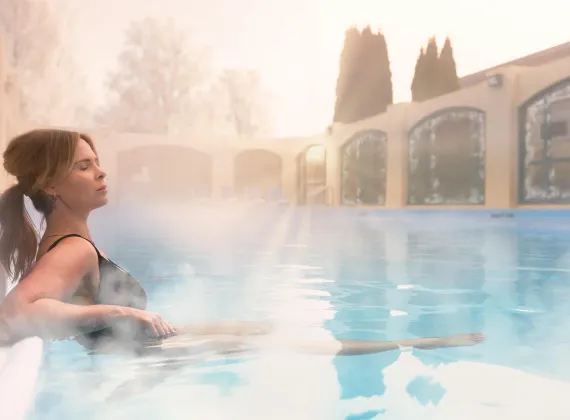 Woman relaxing in a hot tub.